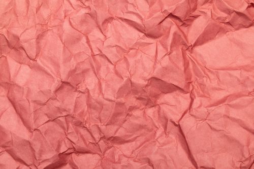Free Pink crumpled paper with a textured, wrinkled surface ideal for backgrounds. Stock Photo