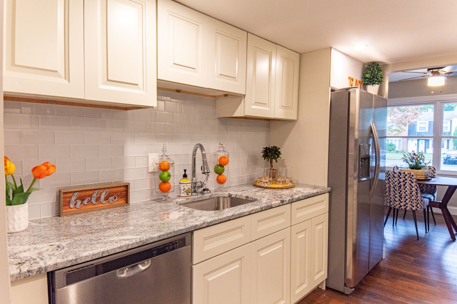 Bright stylish kitchen with white cabinets and granite counter
