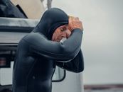 Woman in Black Leather Jacket Covering Her Face With Her Hand