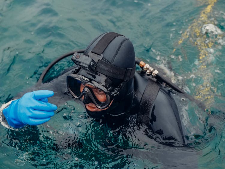 Scuba Diver In Diving Gear Swimming On Sea