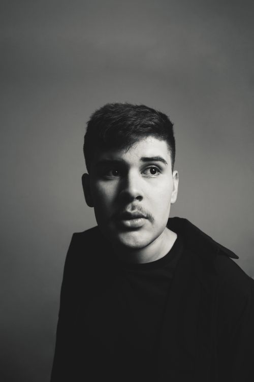 Free Black and white portrait of a young man with a thoughtful expression, captured in a close-up shot. Stock Photo