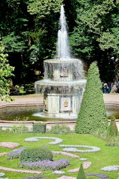 Captivating garden with a flowing fountain, lush greenery, and floral arrangements.