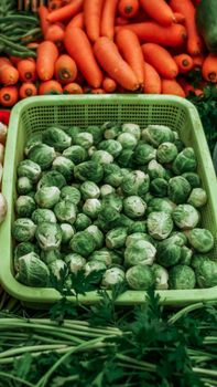 Vibrant display of fresh Brussels sprouts, carrots, and vegetables at a Mexican farmers market.