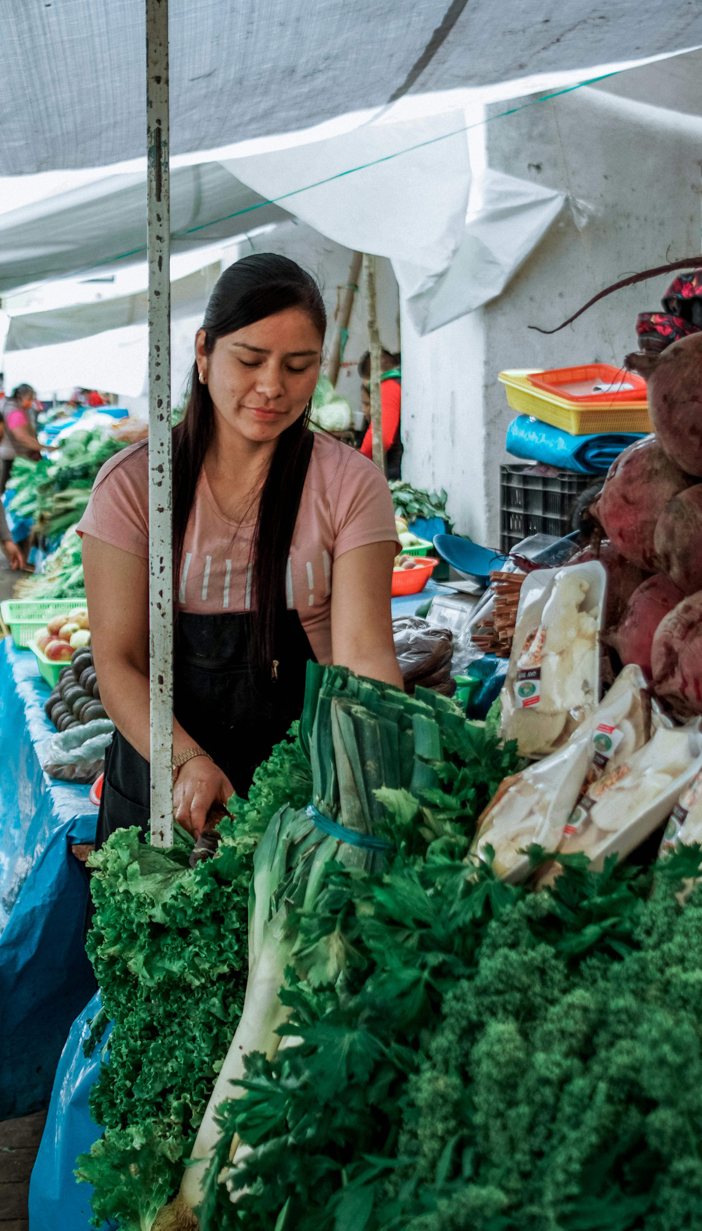 female merchant selling fresh produce vegetables