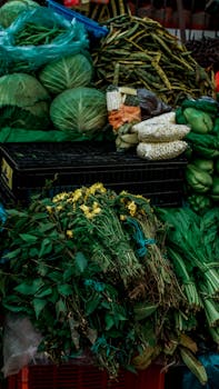 A colorful assortment of fresh vegetables and herbs at a Mexican farmers market stall.