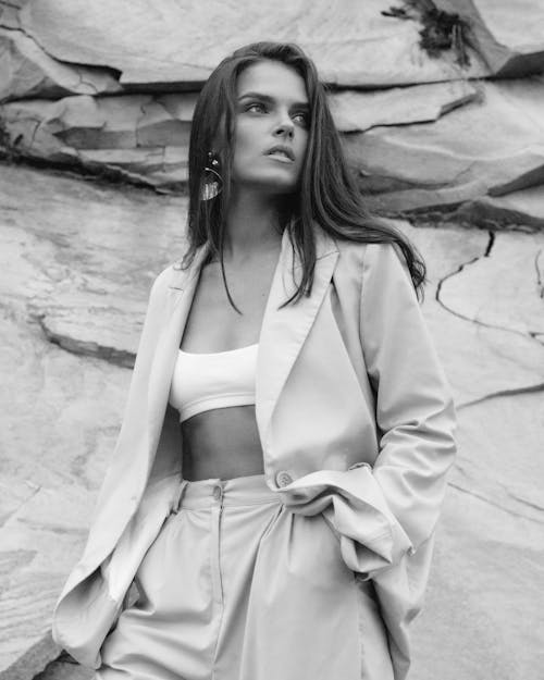 Black and White Photo of a Model Wearing a Blazer Over Sports Bra