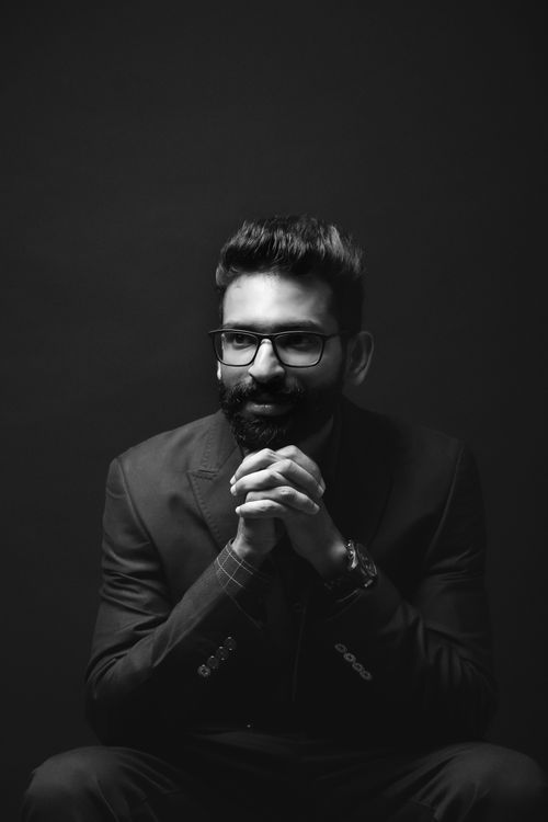 Free Striking black-and-white portrait of an adult man with a beard and glasses in a contemplative pose. Stock Photo