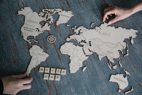 Hands and Wooden World Map