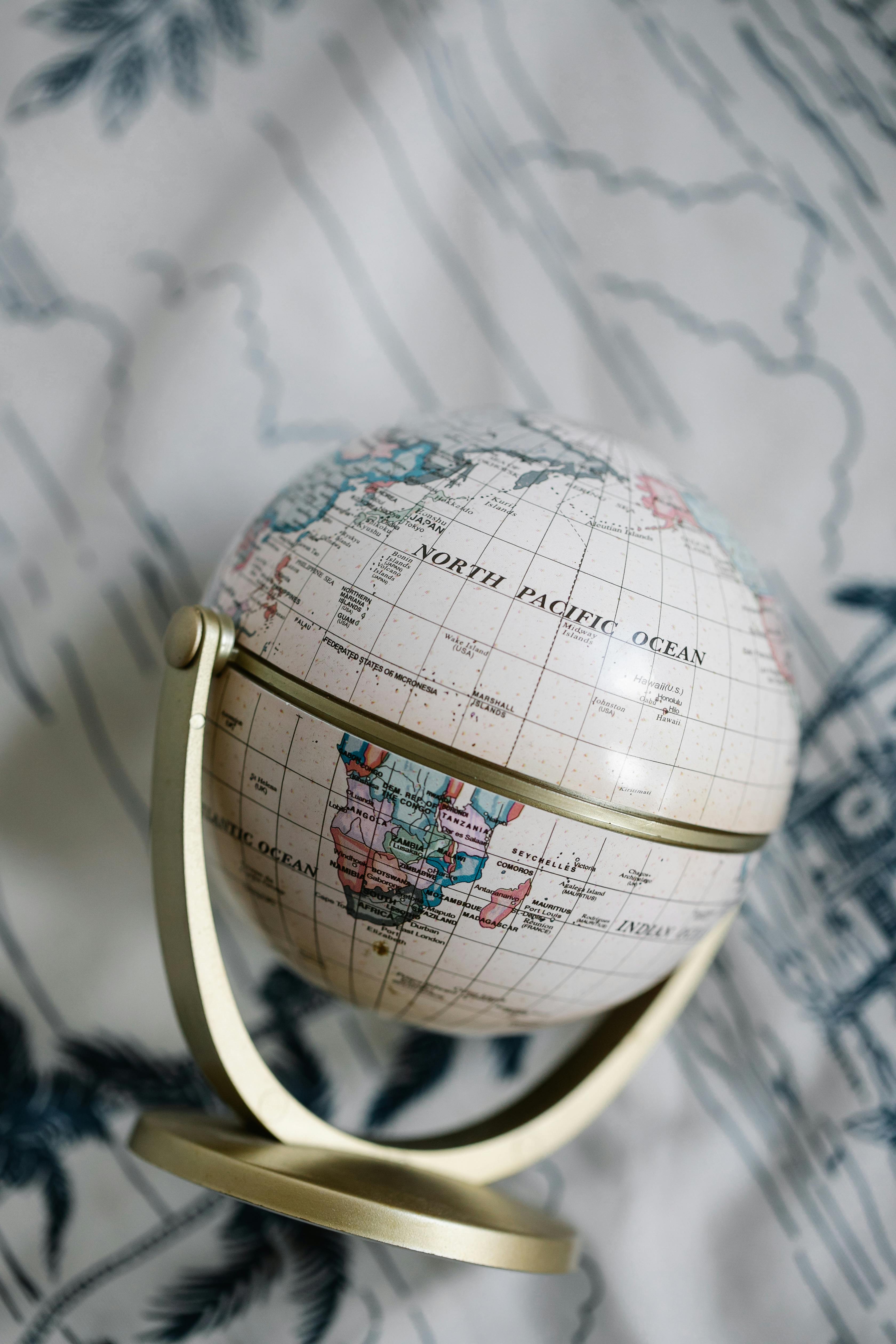 desk globe on a blurred white and green background