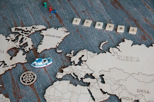 Wooden world map featuring a miniature boat, compass rose, and 'travel' tiles.