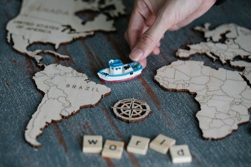 Toy Ship near Wooden Map