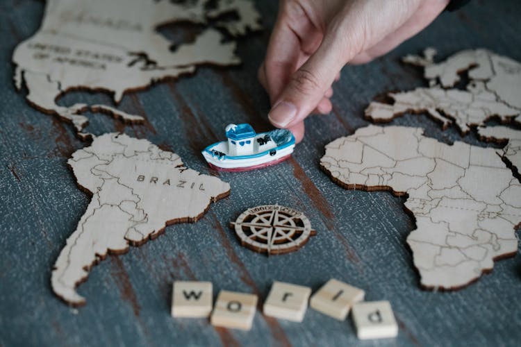 Toy Ship Near Wooden Map