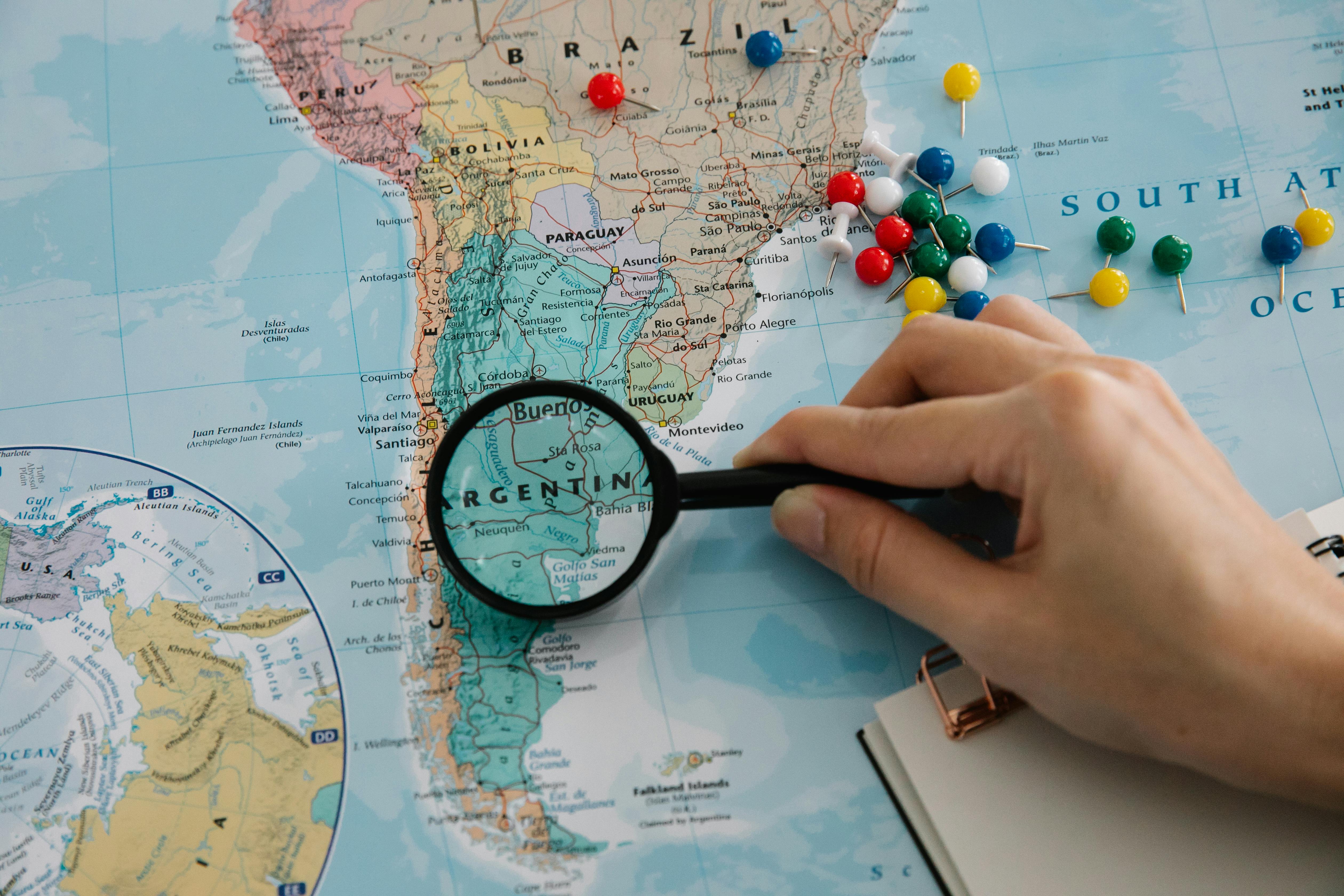 Person Using Magnifying Glass On A Map · Free Stock Photo