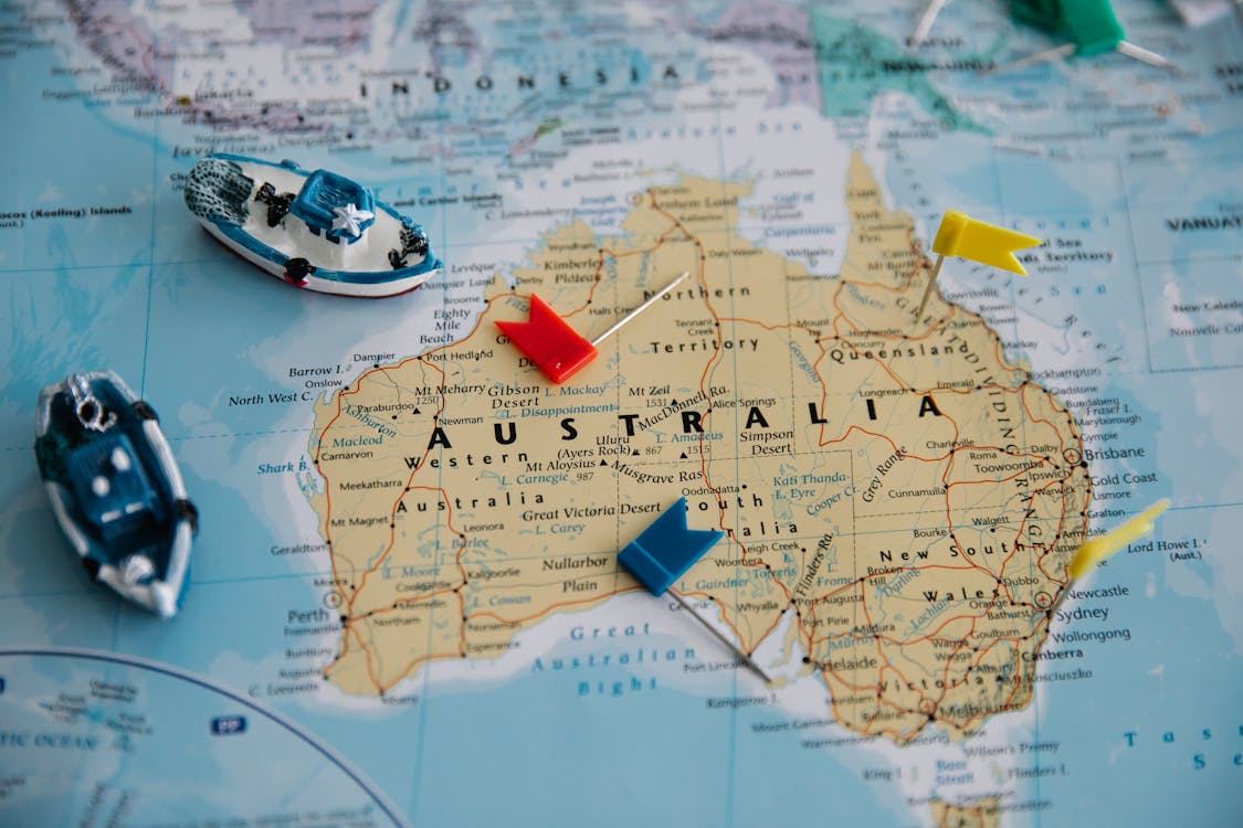 Free Toy Ships and Flags on Australia Map Stock Photo