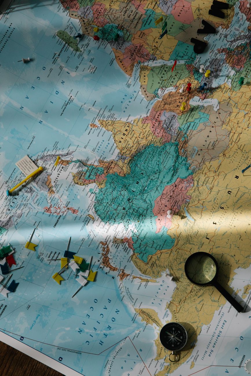 Compass and magnifying glass on a world map, representing retirement destination planning