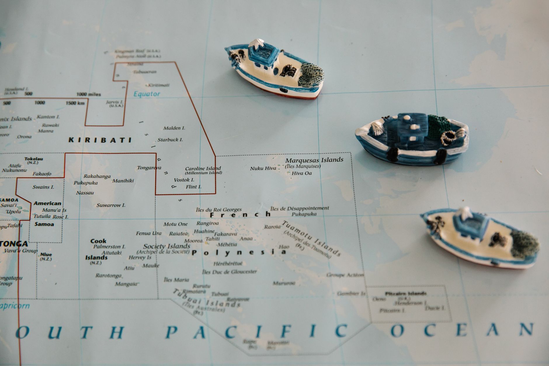 Miniature toy ships placed on a map of the South Pacific Ocean, featuring Kiribati.. Photo by Lara Jameson on Pexels
