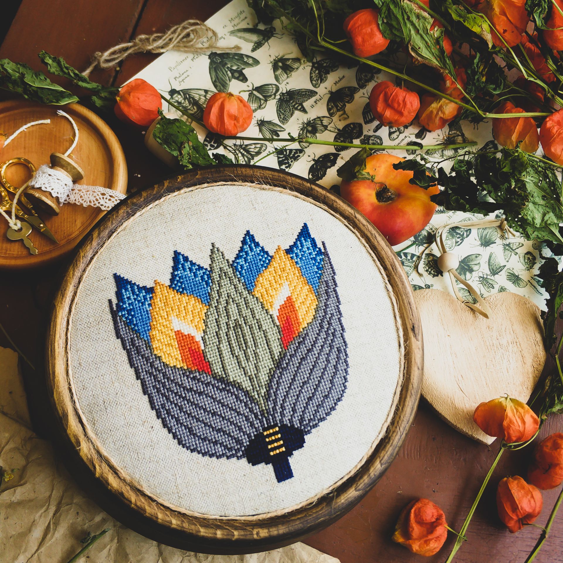Cross-stitched lotus design in an embroidery hoop