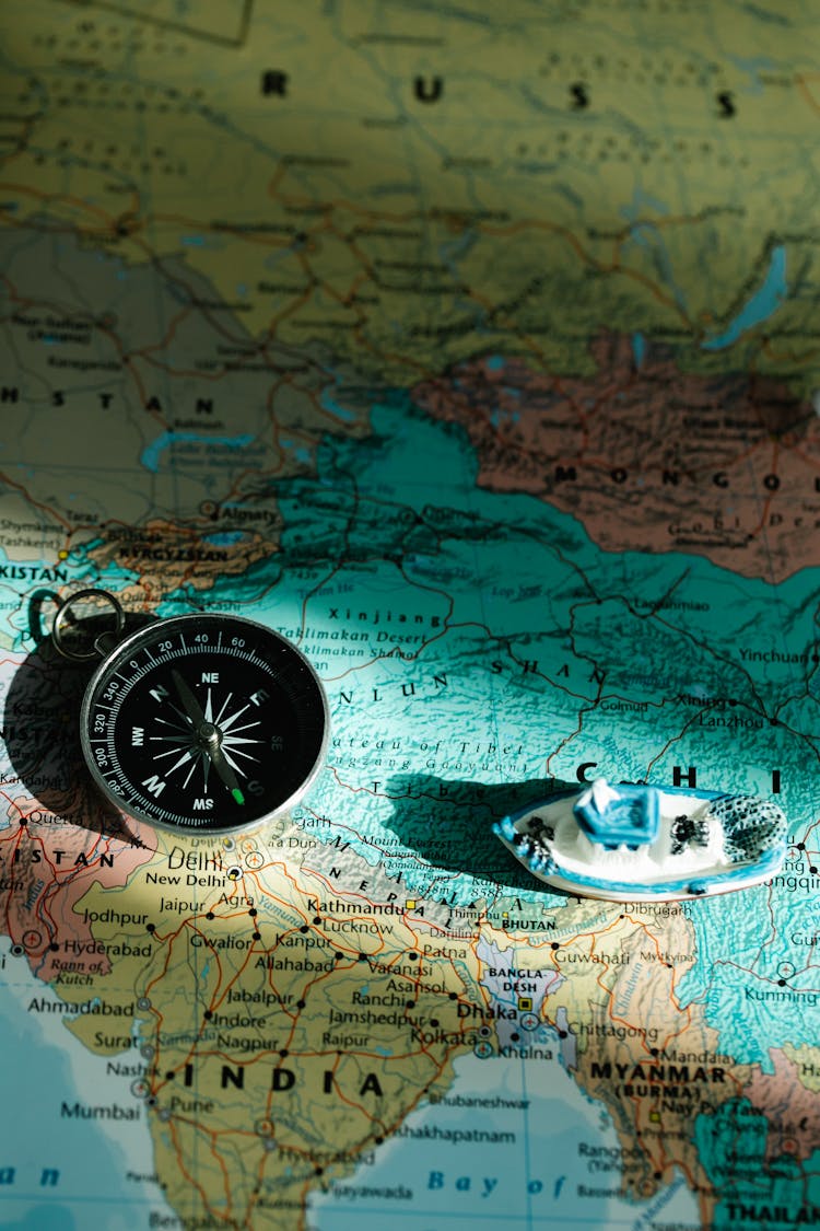 Compass And A Toy Boat On A Map 