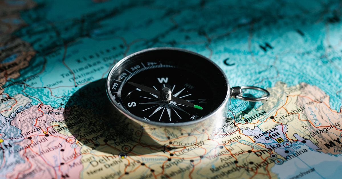 Compass on Paper Map · Free Stock Photo