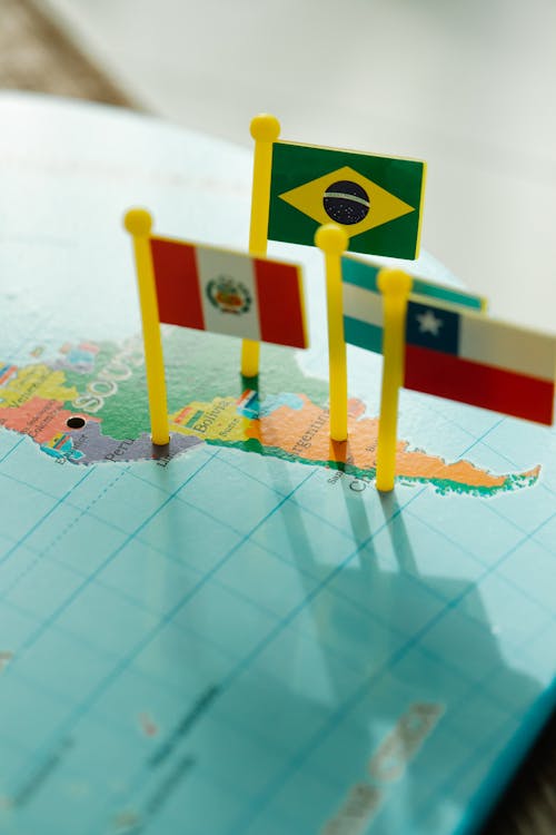 Free Close Up Photo of a Toy Flags Pinned on a Map Stock Photo