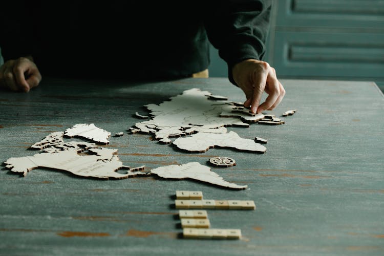 Person Completing A World Puzzle