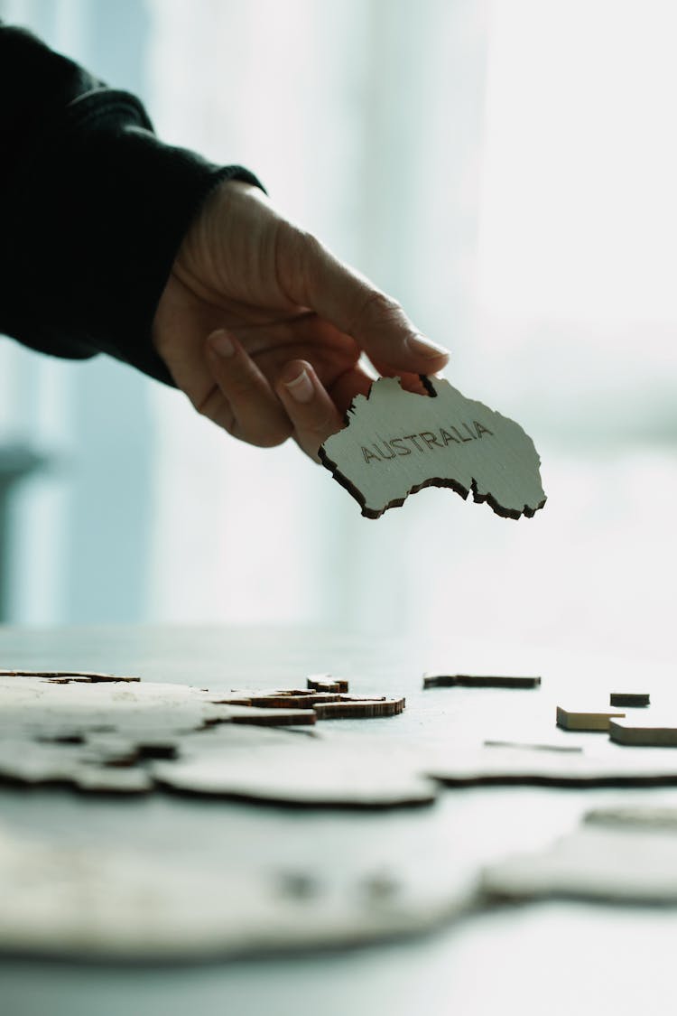 Holding A Puzzle Piece Of Australia