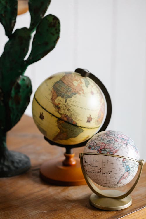 Free Globe World Maps on Wooden Surface Stock Photo