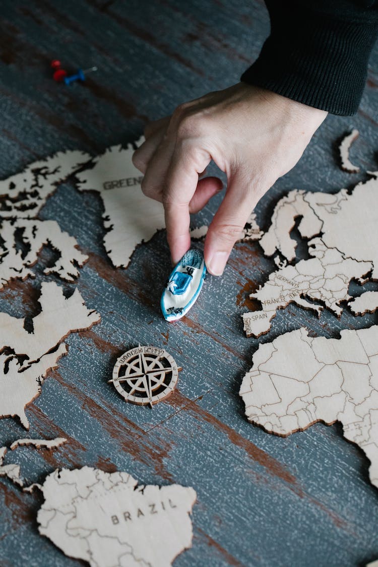 Wooden Cutout Map On A Floor And Plastic Ship Model