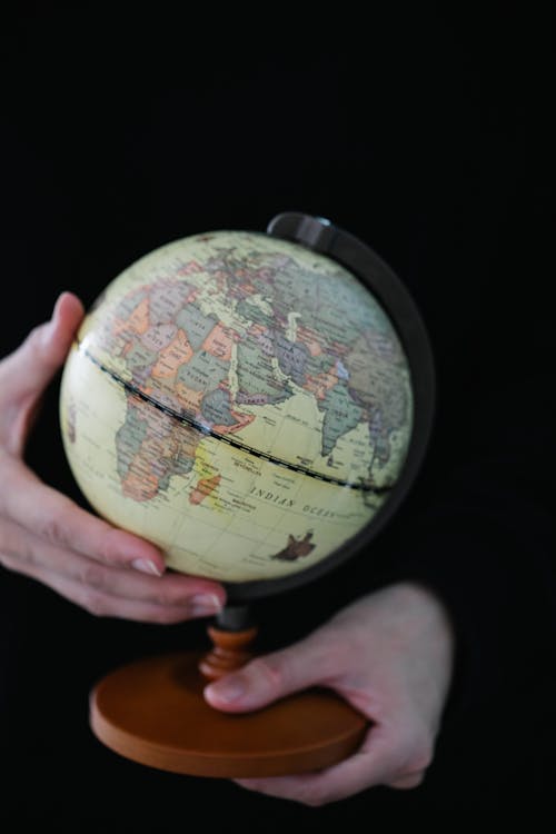 Person Holding a Globe