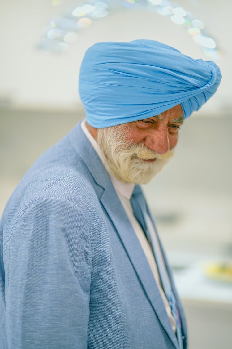 Man Wearing Blue Suit And Blue Turban Smiling