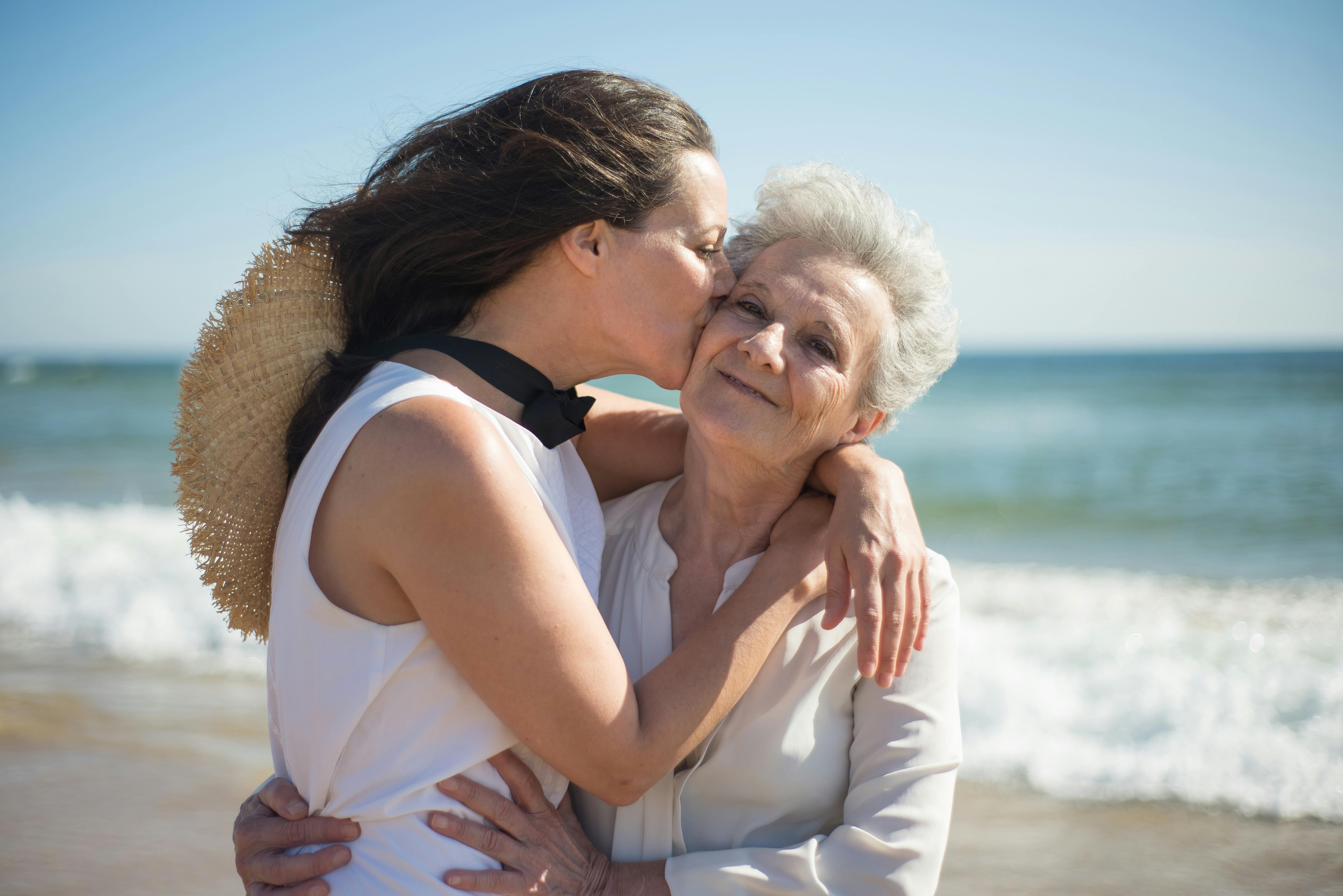 A woman kissing her old mother