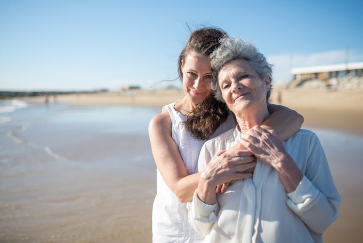 Woman Hugging Her Mother At The Beach