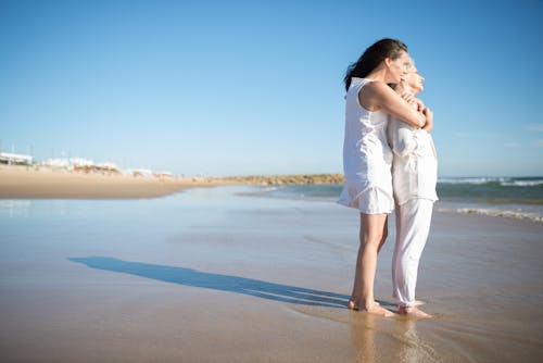 Free Mother and Daughter Standing on Shore Stock Photo