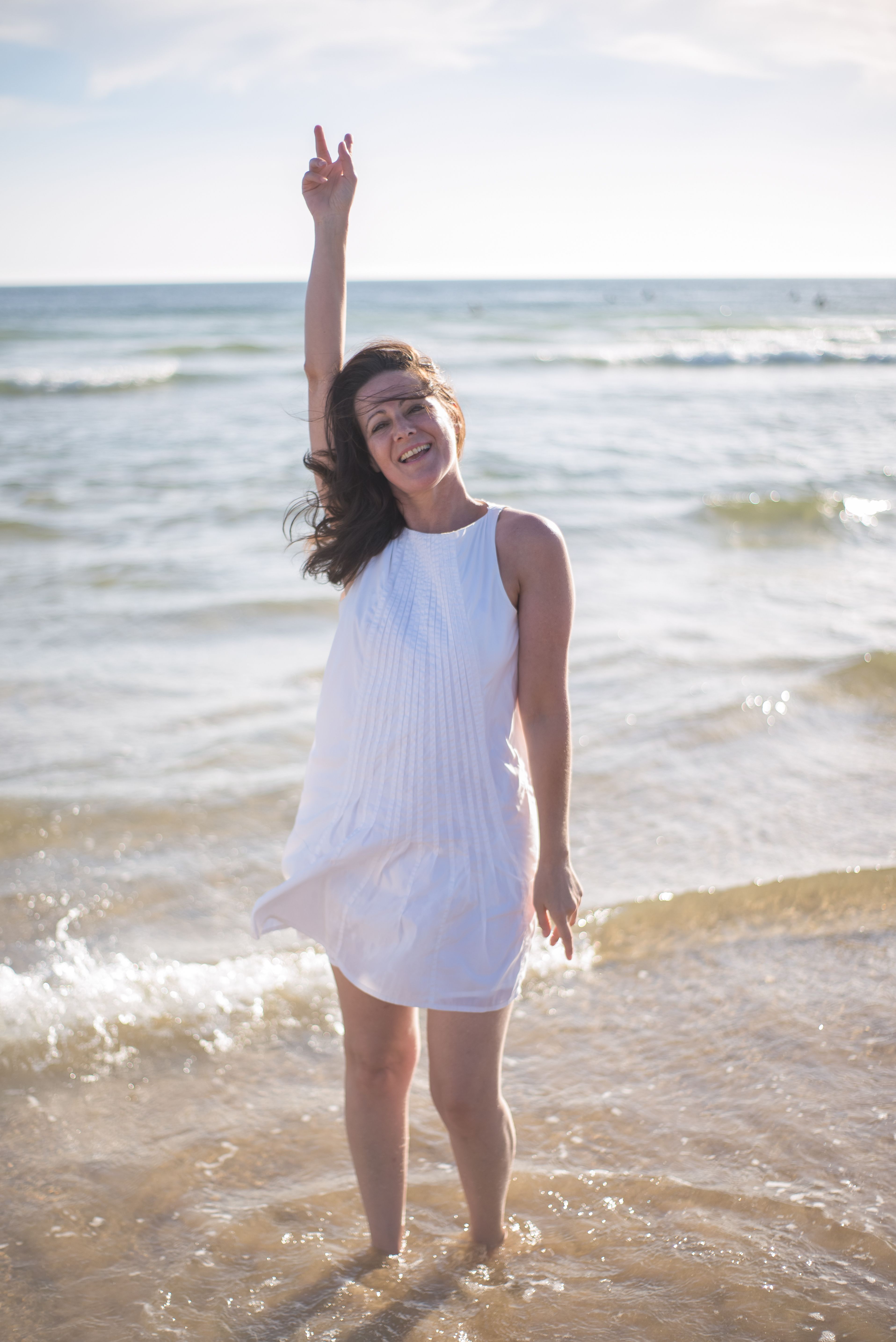 Woman in White Dress Standing on Beach · Free Stock Photo