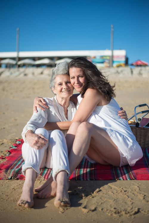 Free A mother and daughter share a loving moment on a sunny beach in Portugal. Stock Photo