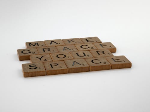 Wooden Letter Tiles on White Surface