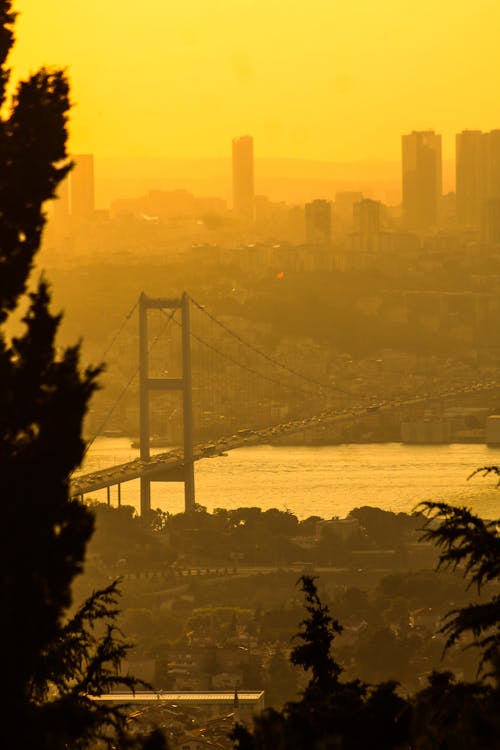Panorama of Bosphorus Bridge against Yellow Sky, Istanbul, Turkey
