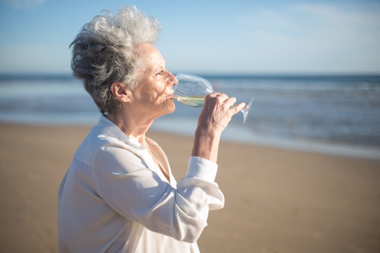 Elderly Woman Drinking From A Wine Glass