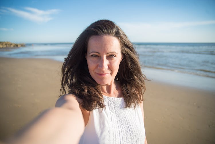 Woman Taking A Selfie On The Beach 