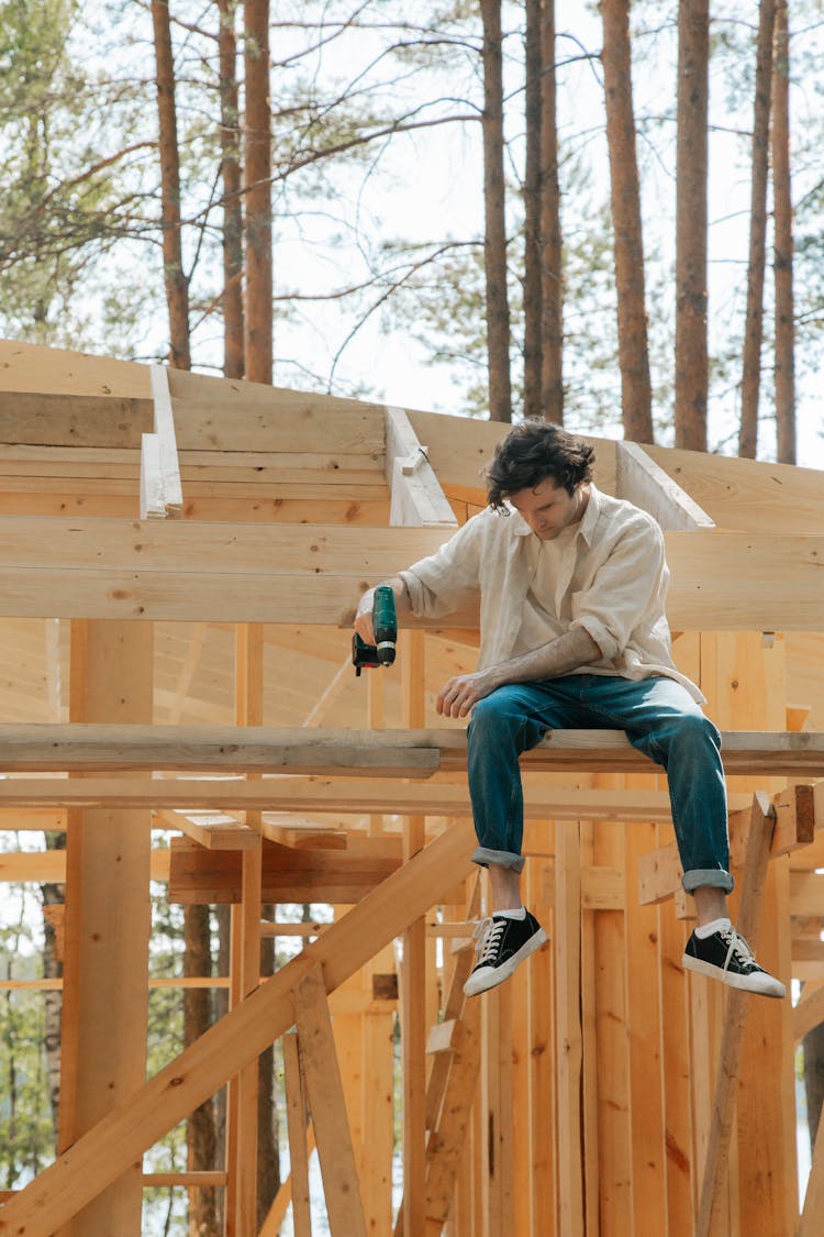 Man Drilling On Wooden Panel