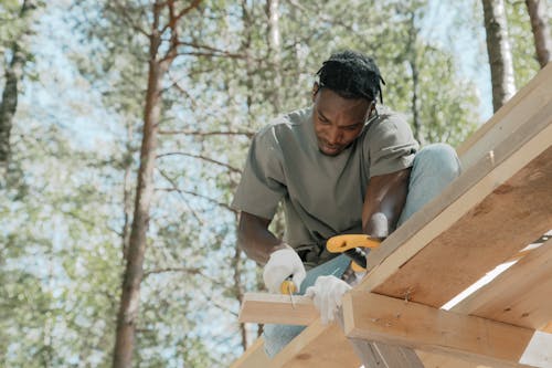 Man sawing a Wooden Panel 