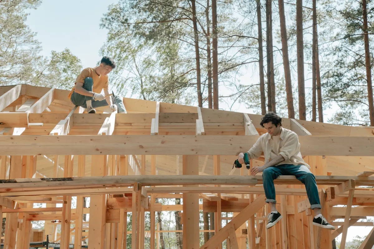 Professional carpenters working together on wooden trusses and roof framing in Australia