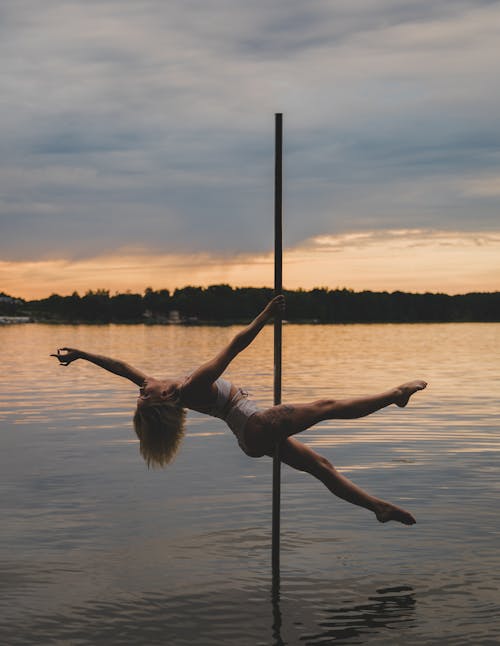 A Woman Doing Pole Dancing on the Lake 