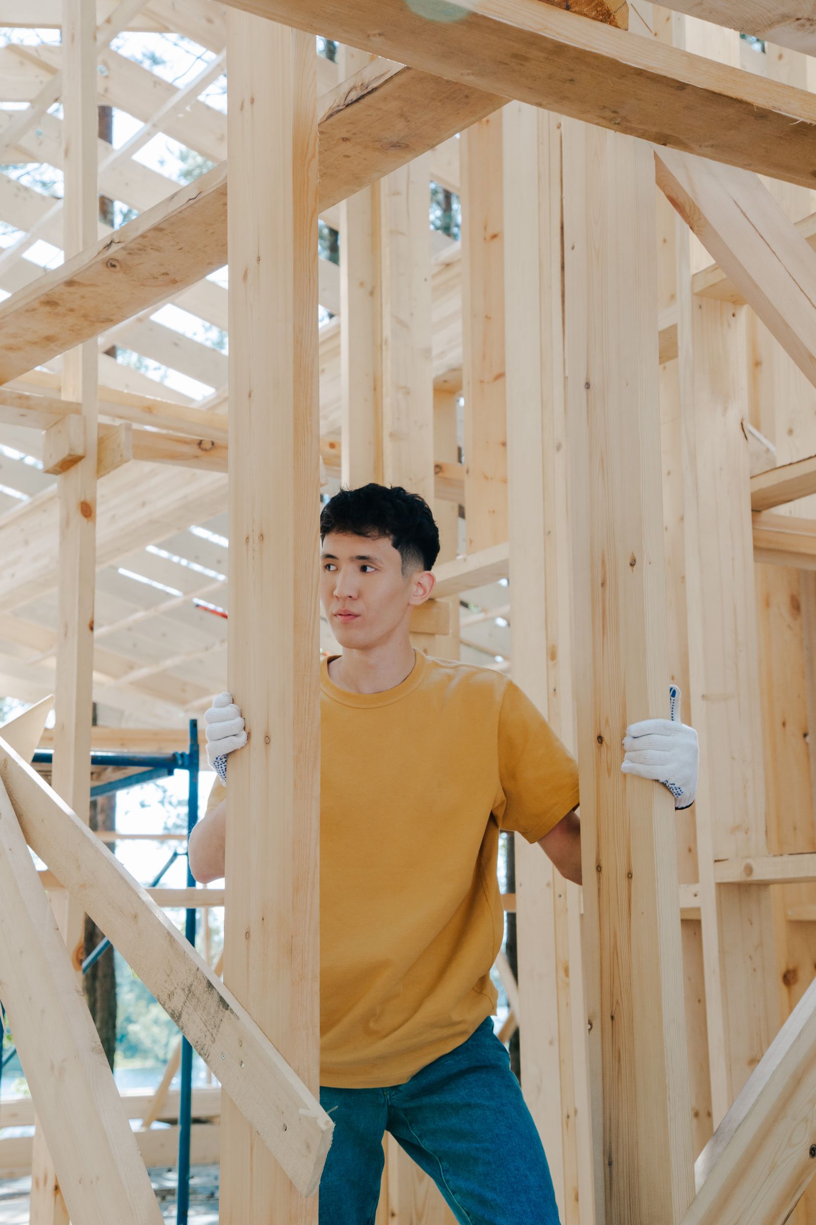 Contractor inspecting wooden framing at a job site
