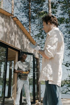 Construction workers building a wooden cabin in a sunlit forest. Ideal for nature and architecture themes.