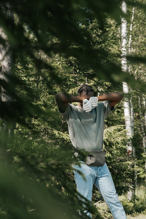 
A Man Wearing Gloves and Denim Pants