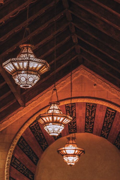 Free Ornate chandeliers in a vintage interior design create an elegant ambiance with warm lighting. Stock Photo