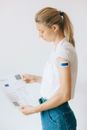 Woman in White Shirt Holding White Printer Paper