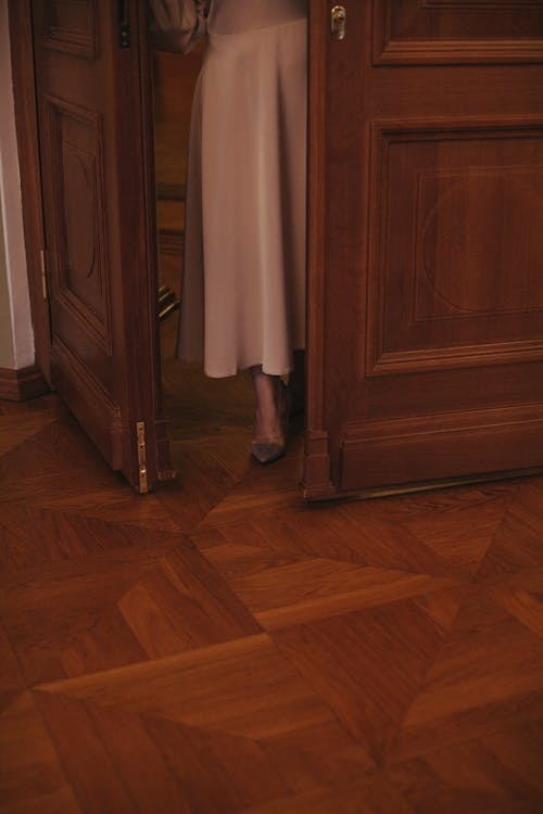 Person Entering a Room with Wooden Flooring