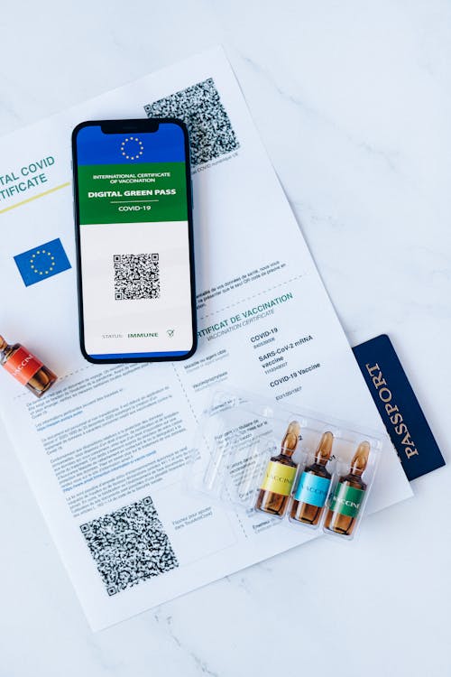 Free Vaccination Document and a Smartphone Stock Photo
